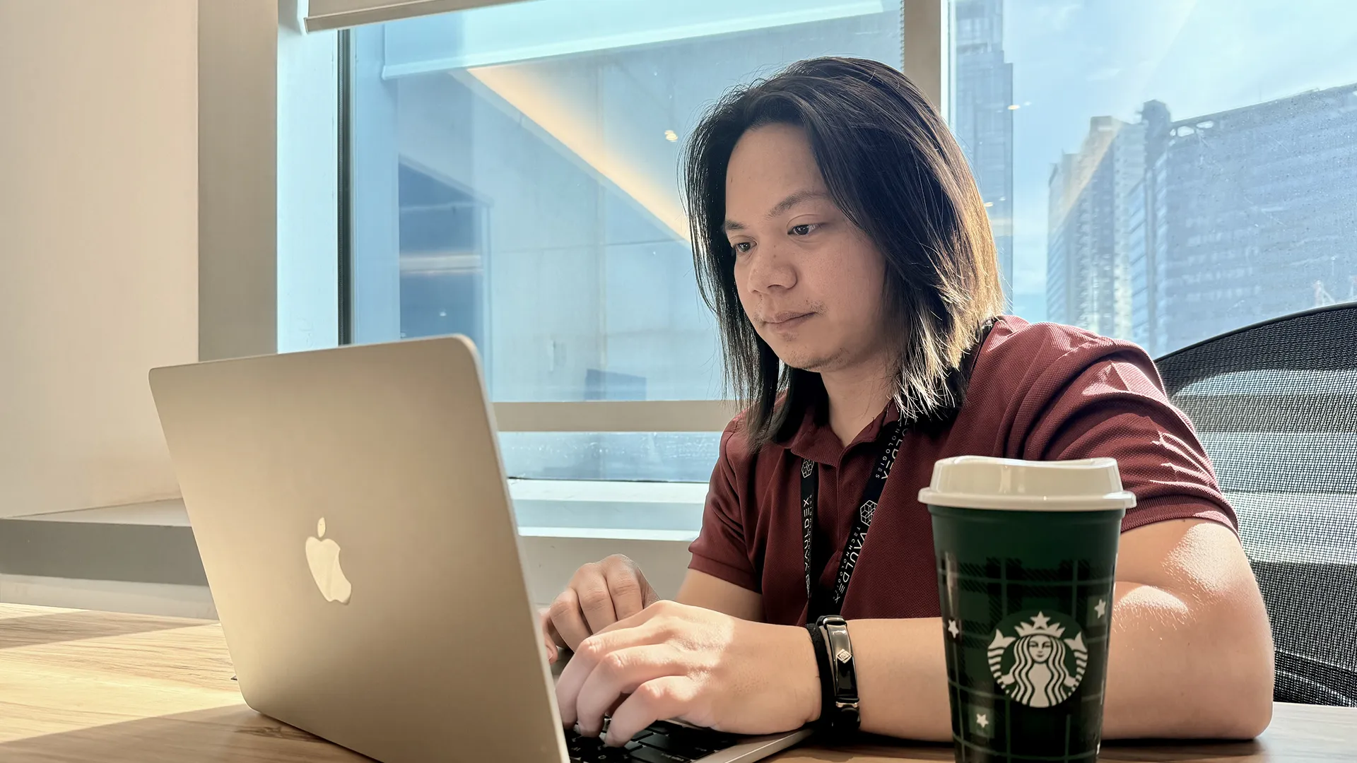 Kynji is working on something by his laptop