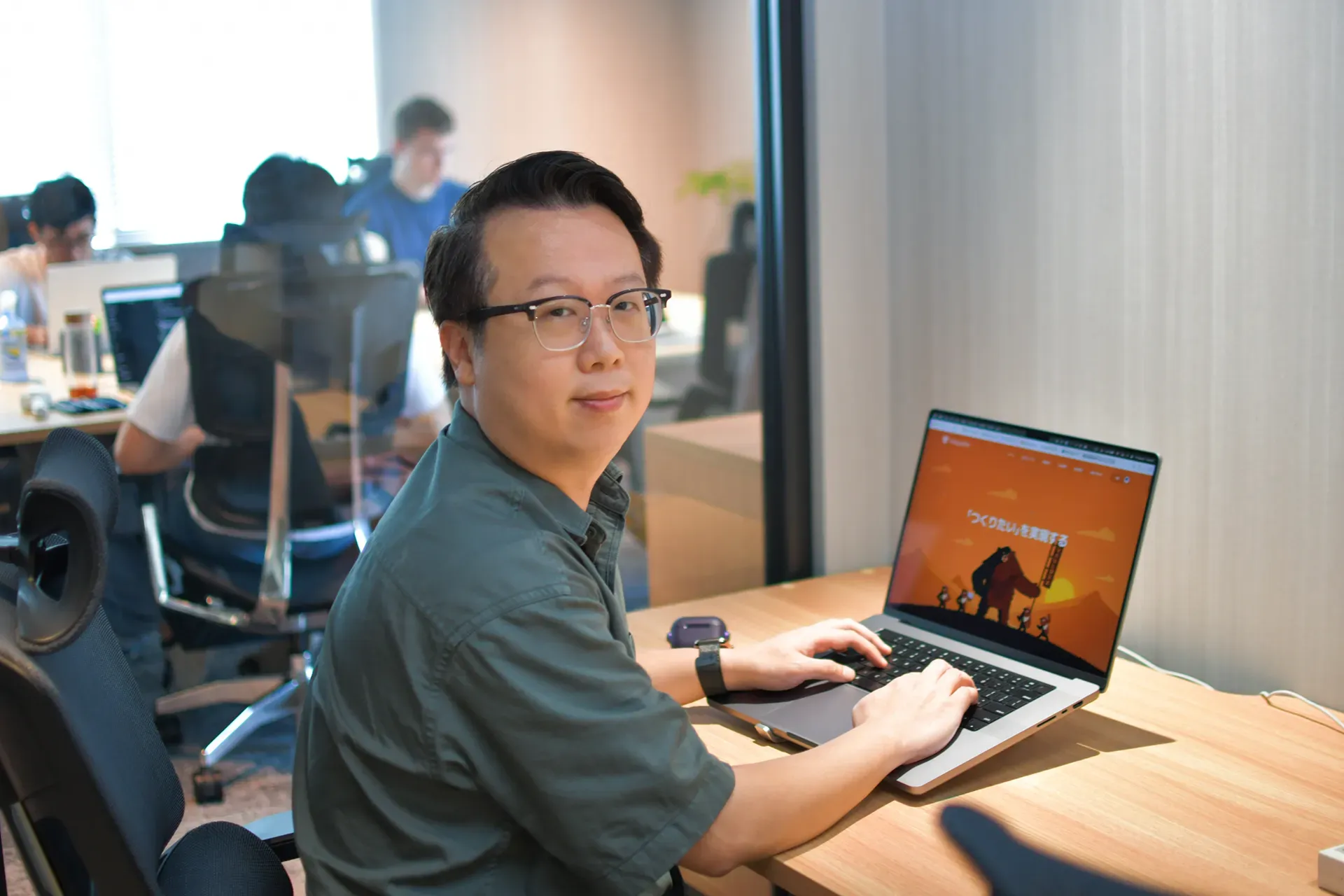 Jason is sitting on the desk.webp