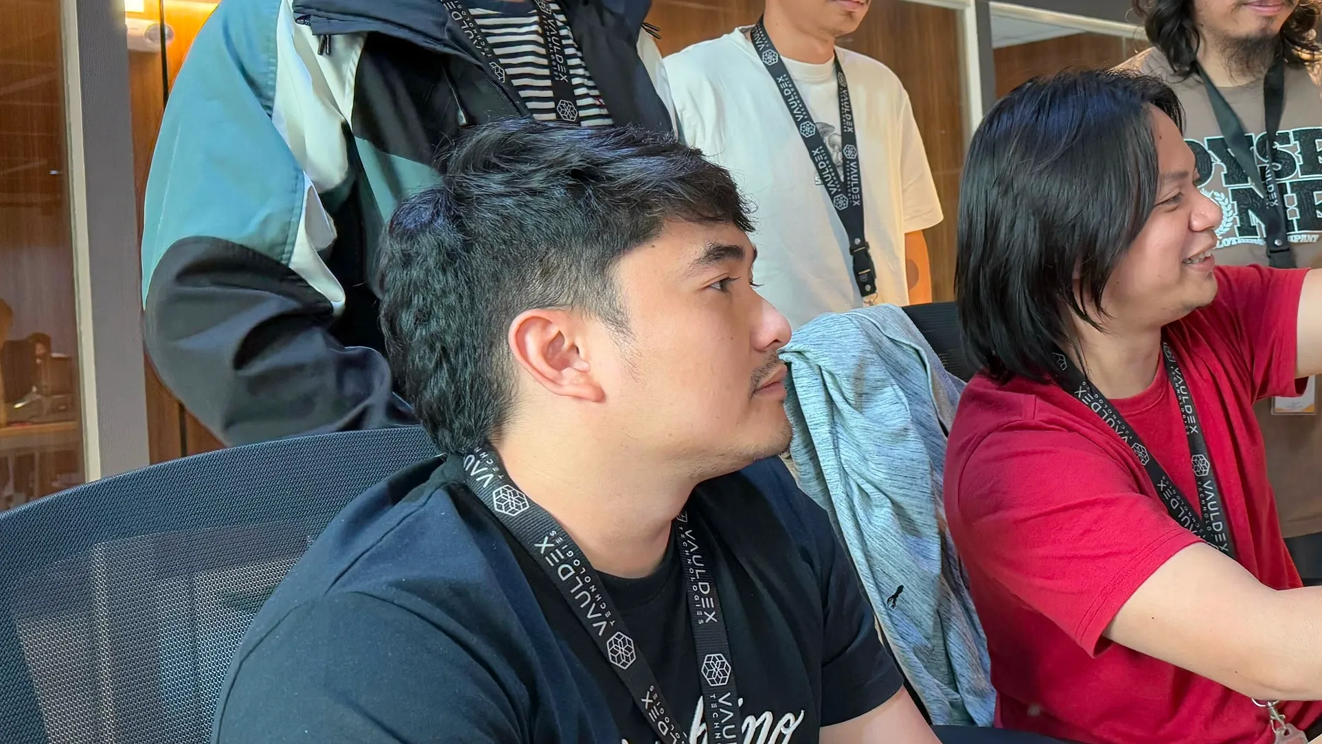 Kem is looking at screen with his colleague