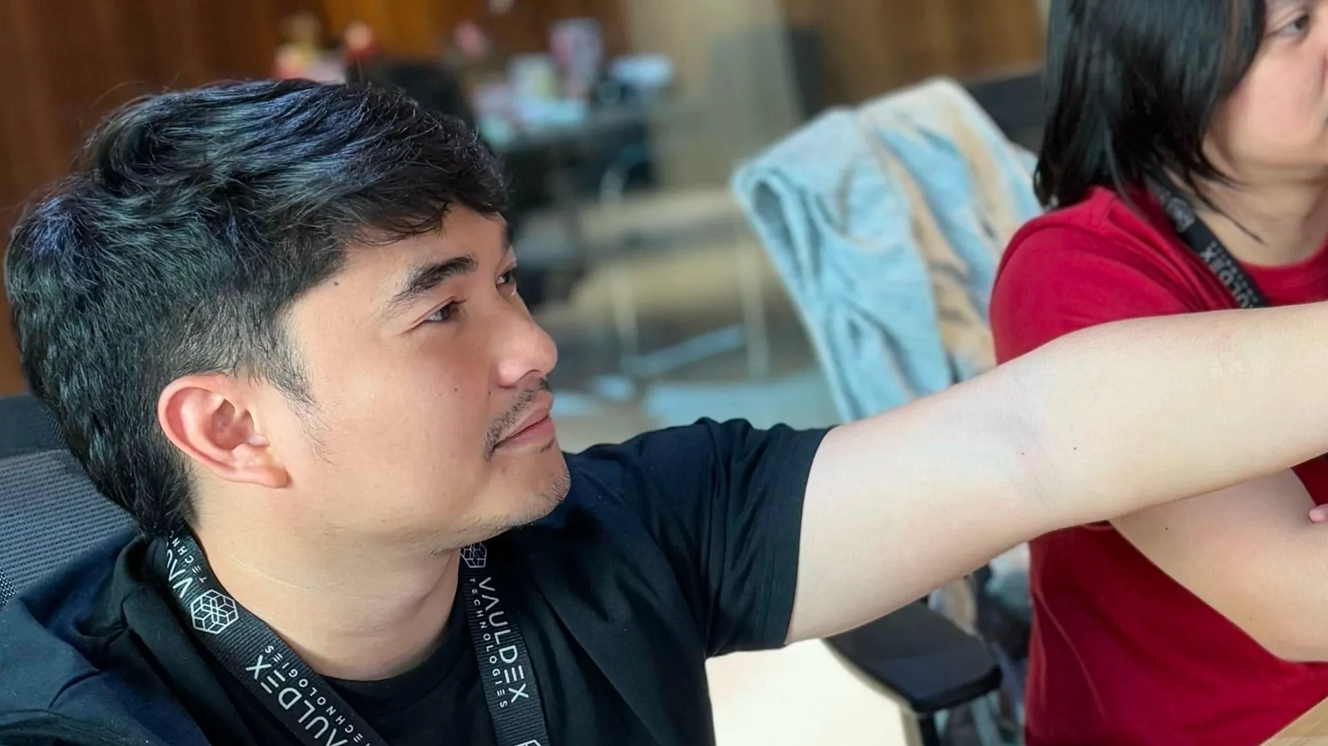 Kem is pointing out something with his hand